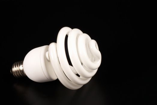 Energy saving bulb isolated on black with copy space