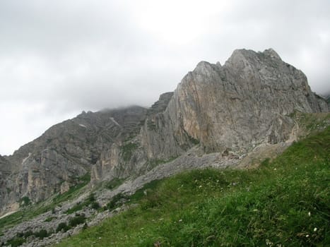 Mountains; rocks; a relief; a landscape; a hill; a panorama; Caucasus; top; a slope; clouds; the sky; a landscape