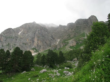 Mountains; rocks; a relief; a landscape; a hill; a panorama; Caucasus; top; a slope; clouds; the sky; a landscape