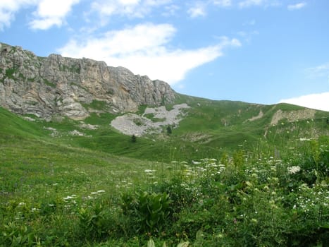 Mountains; rocks; a relief; a landscape; a hill; a panorama; Caucasus; top; a slope; clouds; the sky; a landscape