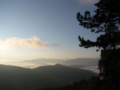 Mountains; rocks; a relief; a landscape; a hill; a panorama; Caucasus; top; a slope; clouds; the sky; a landscape