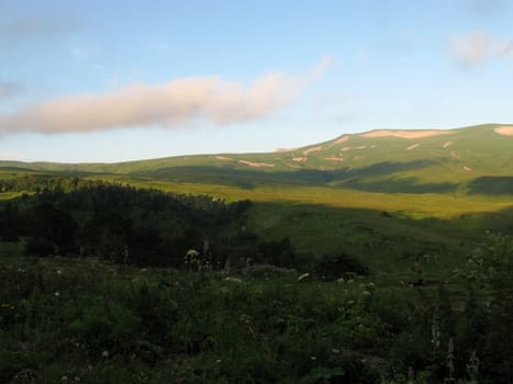 Mountains; rocks; a relief; a landscape; a hill; a panorama; Caucasus; top; a slope; clouds; the sky; a landscape