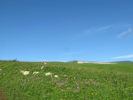 Mountains; rocks; a relief; a landscape; a hill; a panorama; Caucasus; top; a slope; clouds; the sky; a landscape