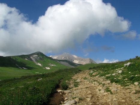 Mountains; rocks; a relief; a landscape; a hill; a panorama; Caucasus; top; a slope; clouds; the sky; a landscape