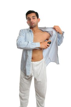 A man using an underarm deodorant perspirant aerosol spray white getting dressed prepared to go out. White background, 
