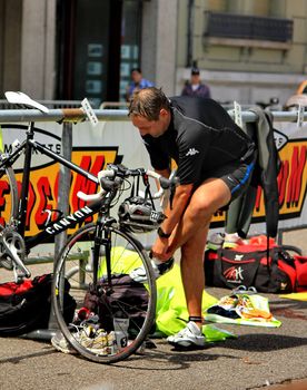 GENEVA, SWITZERLAND - JULY 24 : one unidentified male racing cyclist after the swimm race at the international Geneva Triathlon, on july 24, 2011 in Geneva, Switzerland