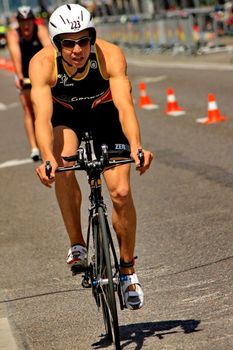 GENEVA, SWITZERLAND - JULY 24 : one unidentified male racing cyclist after the swimm race at the international Geneva Triathlon, on july 24, 2011 in Geneva, Switzerland