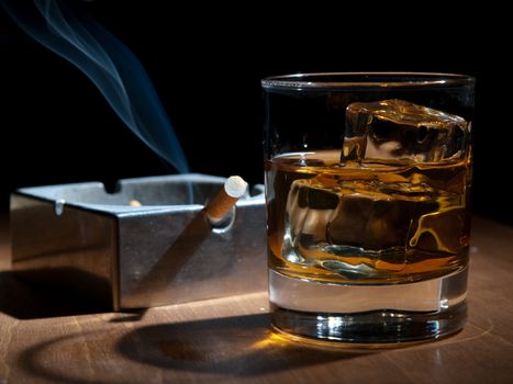 whisky and cigarettes, unhealthy lifestile, lonely drinking at night