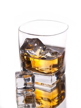 Glass of whiskey on the rocks with an ice cube