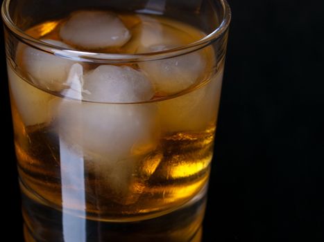 Glass of whiskey with ice