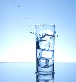 Water spilling over from a glass 