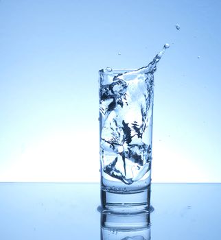 Splash from ice cubes dropped in a glass of water
