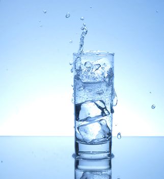 Ice cube splash in a glass of water 