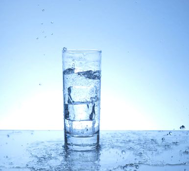 Water spilling from a glass of water 