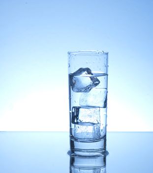 Four ice cubes in a glass of water