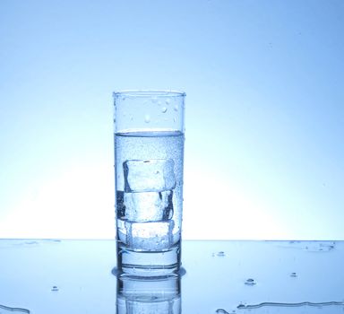 Three ice cubes in a glass of water 