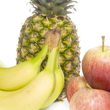 a closeup of a pineapple, bananas and apples