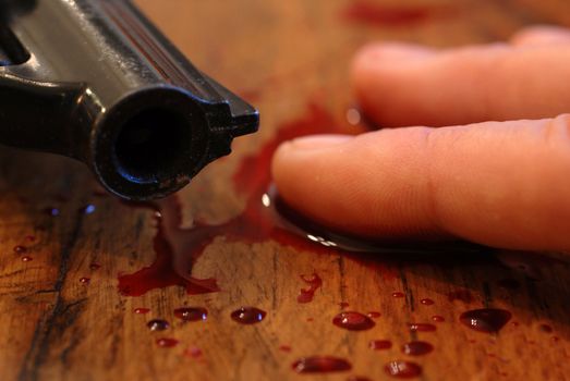 hand of teenager who committed suicide from a bullet of revolver...