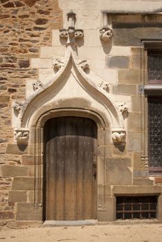 Medieval door made of wood next to a window