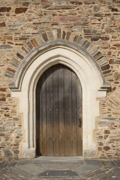 Medieval door made of wood under a vault