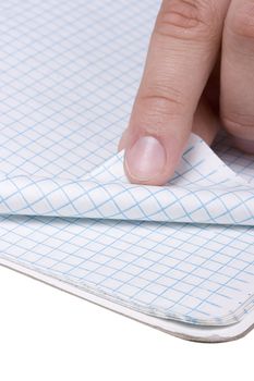 Human hand turning over a page of notebook paper.