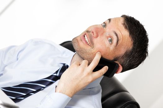 happy businessman on the phone in office