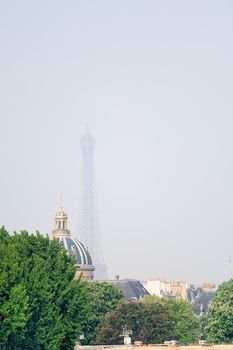 Panorama of roofs and Eiffel tower in the fog