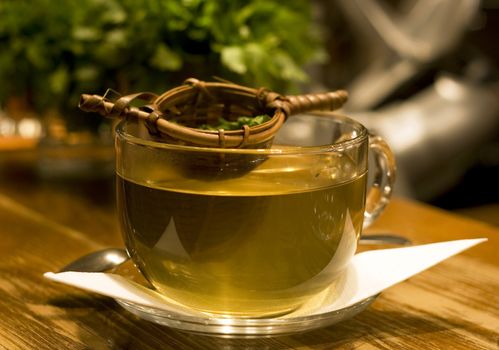 Big cup of peppermint tea on bar counter. Indoor shot.