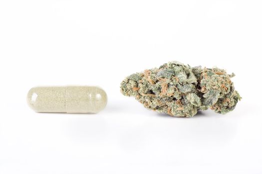 Green capsule and dried bud of cannabis