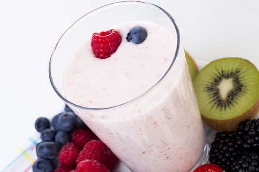 Fresh fruit surrounding fruit smoothie