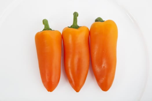 Sweet orange peppers on white plate