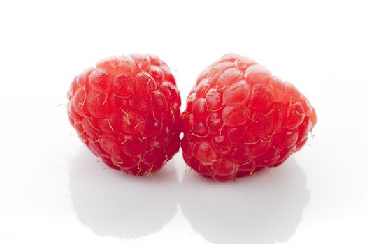 Raspberries on white background.