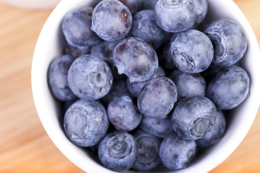 White bowl of blueberries shot from directly above.