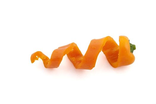 Sweet orange pepper cut into curls and isolated on white.