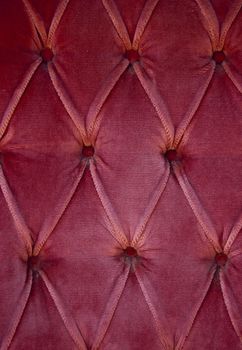 Luxury red fabric texture on an old sofa