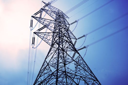 Electricity pylons with long cable at day