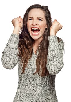 A strong image of a very upset and angry woman screaming and clenching her fists. Isolated on white. 