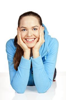 Beautiful portrait of a young attractive woman lying down smiling on the floor