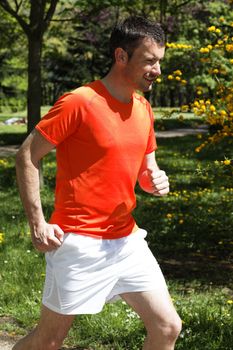 man running in a park in spring