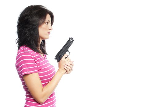Attractive hispanic woman holding a hand gun on a white background
