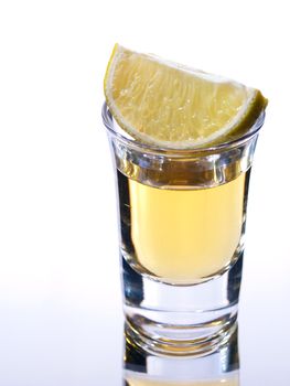 Tequila in a shot glass with lime