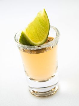 A shot of tequila and lime, rich salt rim