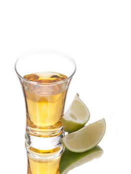 Tequila shot and limes on white