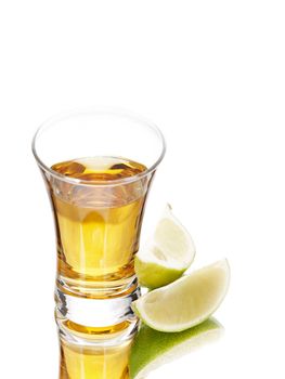 Tequila shot and limes on white