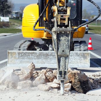 yellow jackhammer on building site in summer