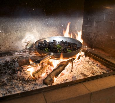 cooking mussels on flame