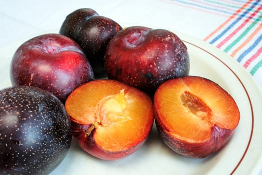 Ripe fresh plums on a plate