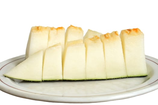 Slised melon on the plate isolated over white background