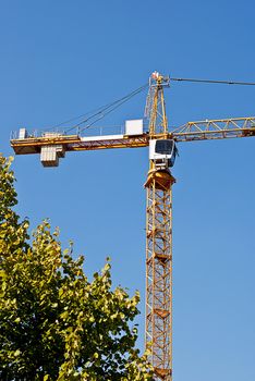 Yellow crane on blue sky background