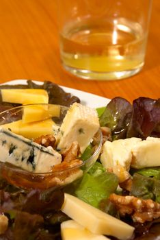 Cheese salad with walnuts dressed with honey